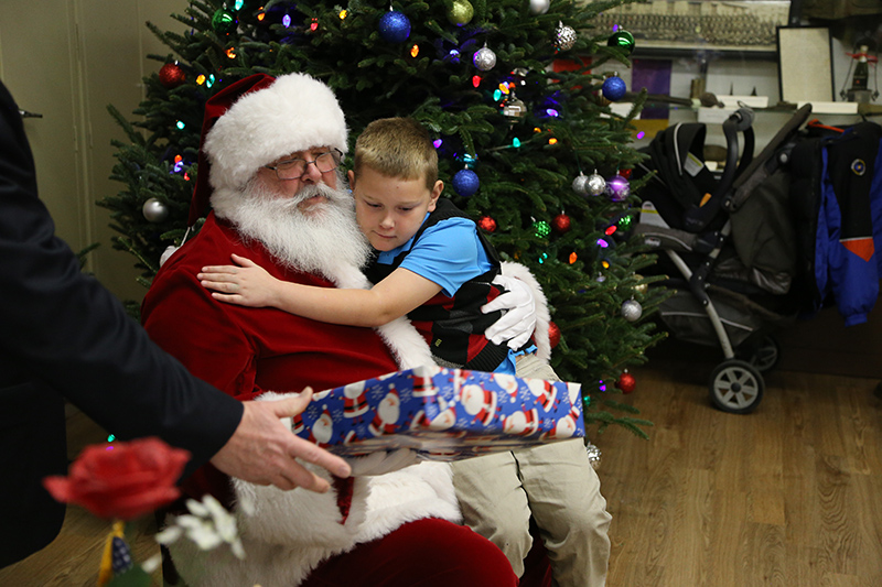 Santa gave lots of presents and received lots of hugs.