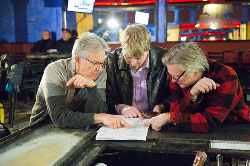 Steve Ross (left), Vogue owner, studies the blueprints of changes to College Avenue. Steve's brother Glenn is on the right.