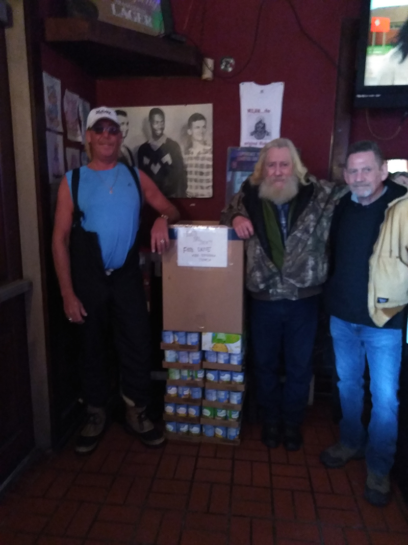Treasurer, R. Andy Ruddell, President, C. Frog Russell turning this year's haul in to Scott Long of NBC's food pantry.