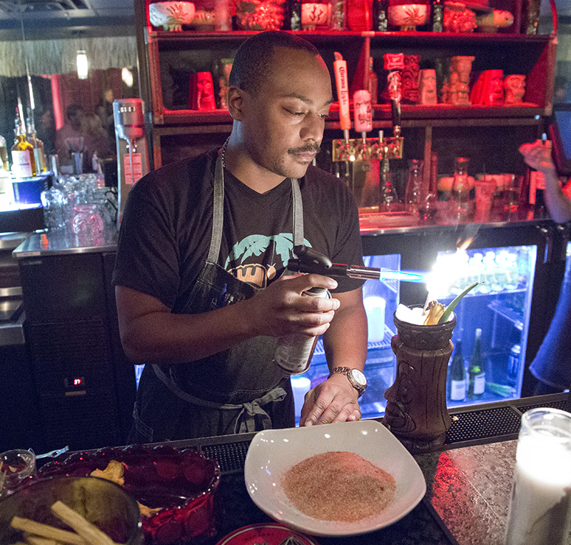 Jessie Beasley puts the final torching touch on a tiki drink