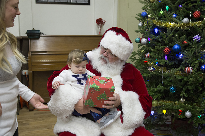 Santa arrived at 5:20pm and took his place by the tree to hand out presents to all of the boys and girls who had been waiting patiently all through dinner.