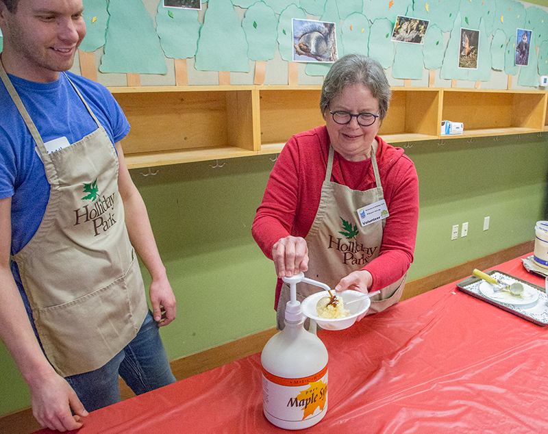 Volunteer Norma Wallman dishes up a maple syrup sundae.