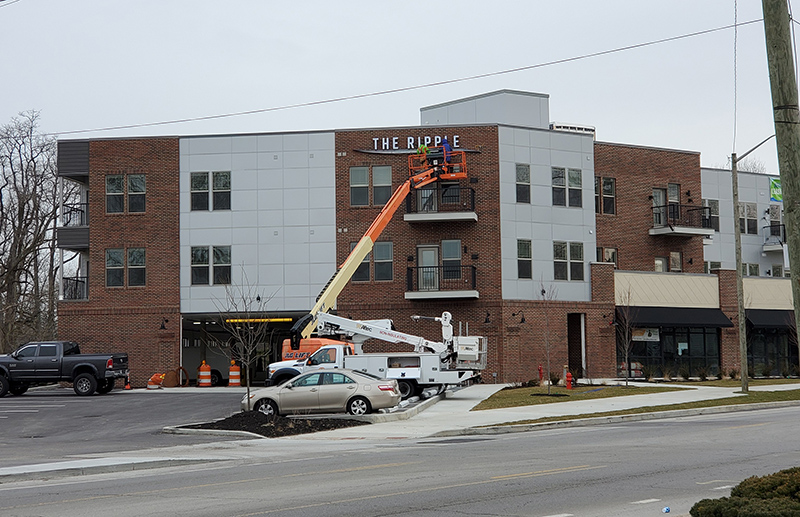 Installing the sign at The Ripple