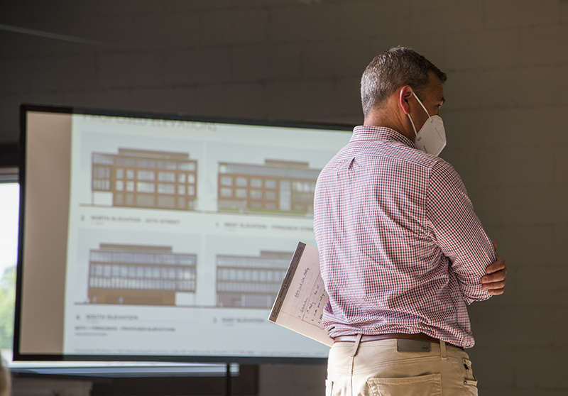 Misha Rabinowitch showing the renderings of the proposed office building.