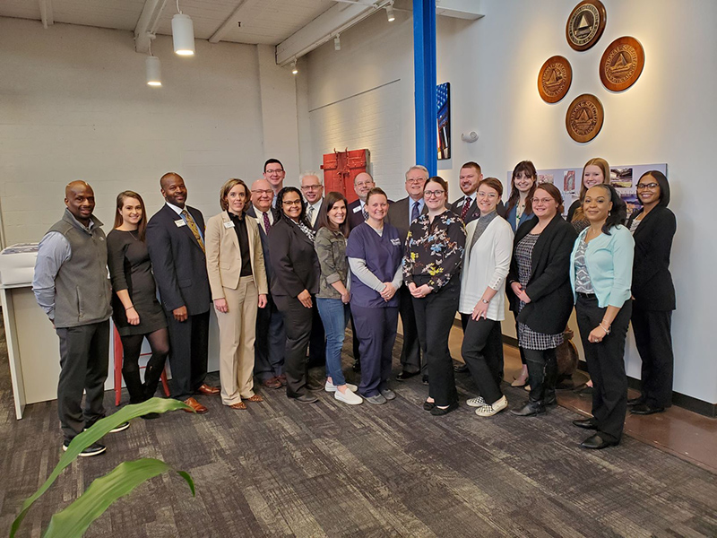 Flanner Buchanan funeral directors gathered on March 8 to celebrate the company's 140th anniversary at its corporate headquarters. Pictured are (left to right) George Brown, Kandace Klingler, Emanuel Smith, Jan Smith, Jay Recker, Russell Beckner, Cari Jones, Tim Taylor, Jamie Weyer, Brian Vaughan, Shannon Yowler, Jerry Roberts, Dana Foster, Mark Worland, Emma Miner, Zoë Norris, Kristen Yonts, Lauren Secor, Stephanie Parrish-Goldsmith, and Omega Thomas.