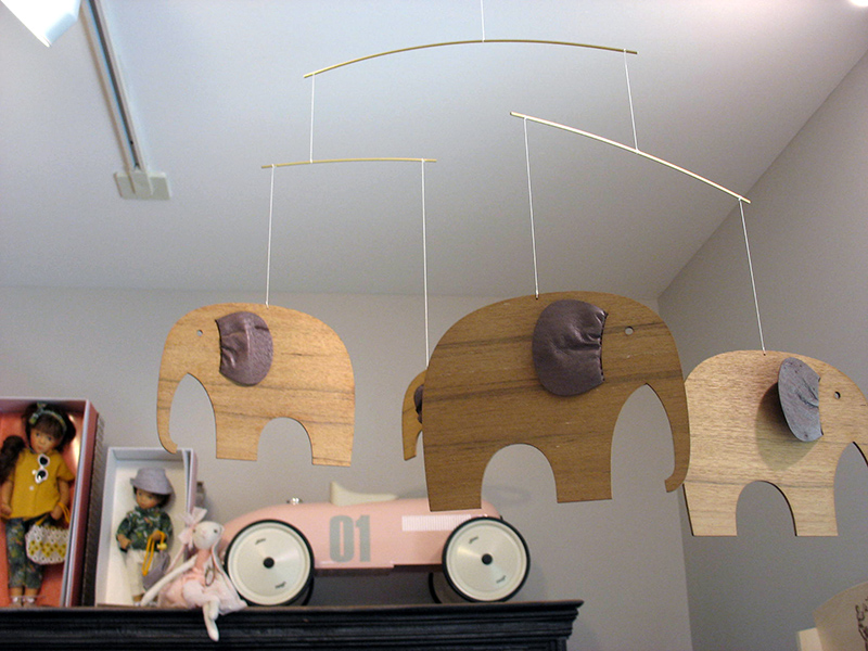 A wooden elephant mobile made in Denmark.