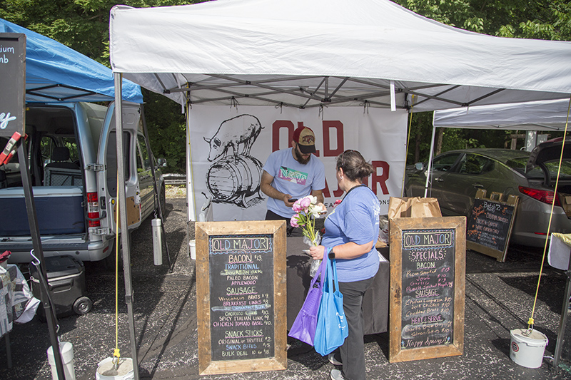 Old Major selling bacon and sausages