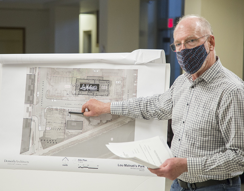 Mark Demerly shows the landscaping buffers on the north side of the small parking lot.