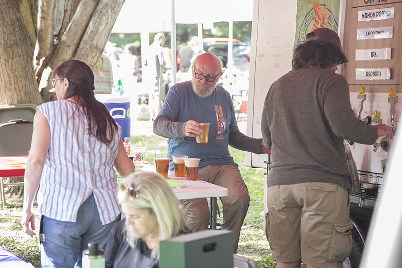 John Hill pouring beers