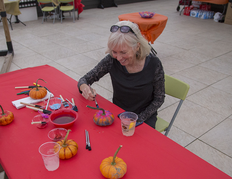 BR Farmers Market director Barbara Wilder painting a pumpkin