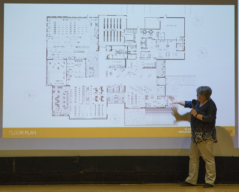 Judy Gray showing the layout of the new library