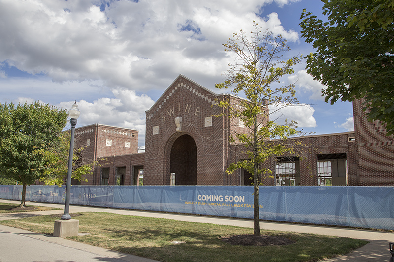 The old swine building is gone, except for the front, and the new building is under construction