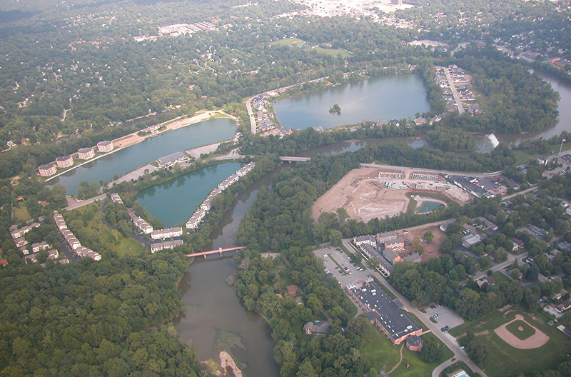 Your editor took this picture of the lakes in Broad Ripple in 2003 when WIBC's Big John Gillis offered a plane ride. The White River surrounds them. The upper left lake is Spirit Lake, with the four condo buildings. The upper right lake is Dawson Lake / Oxbow. The lower lake is Winston Island Woods. The Monon Trail river bridge is in the lower middle, with the Westfield bridge above it. The dam, creating the canal, is to the right of the Westfield bridge. Glendale is at the top. The construction is The Reserve At Broad Ripple. The Indianapolis Art Center and OptiPark are in the lower right.