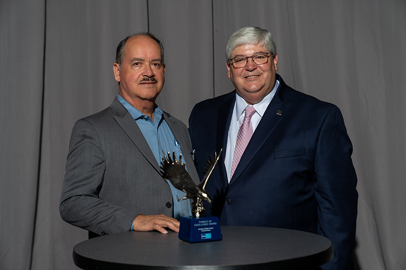 Carlos Figueroa, Senior Vice President, Chief Financial Officer of Flanner Buchanan (left) is shown with Randy Anderson, NFDA Immediate Past President (right) receiving the 2022 National Funeral Directors Association (NFDA) Pursuit of Excellence Award during the NFDA International Convention & Expo held last month in Baltimore, Maryland.