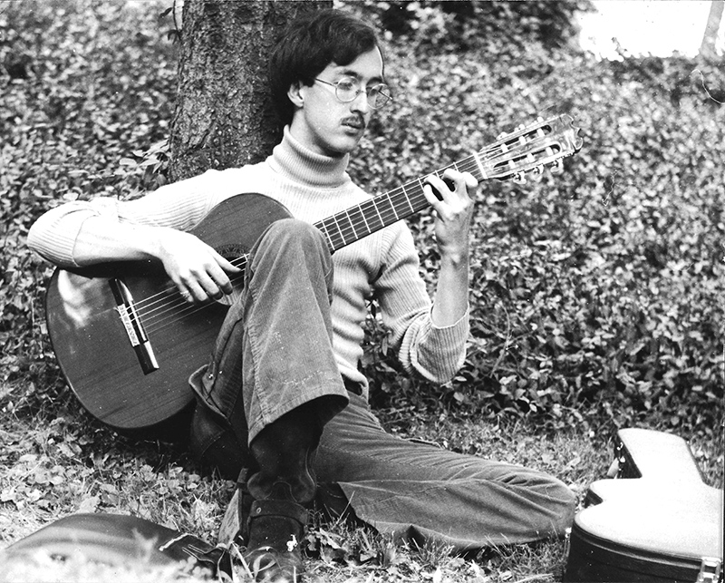 Dan Henkel on the IU Campus playing a classical guitar.