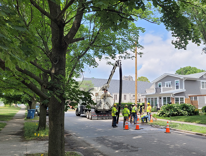 A crew installing a new pole in the 6100 block of Winthrop Avenue