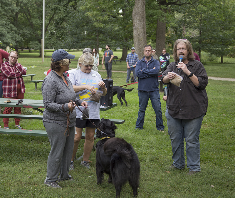 Emcee Dean Metcalf (Producer of Q95's Bob and Tom Show) announces a doggie award