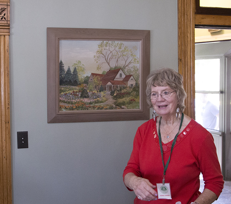 Helen with a painting of the house and garden