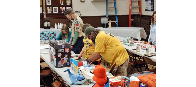 Cub Scout Pack 175 wrapping gifts for children