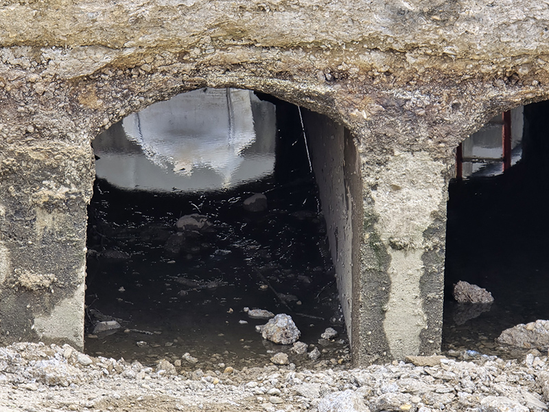The White River used to flow through these channels under the road to fill the canal. These were the original canal gates.