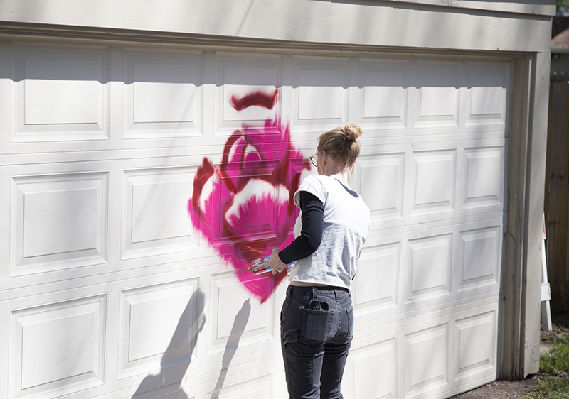 Local artist Megan Jefferson painting a new mural in Flower Alley