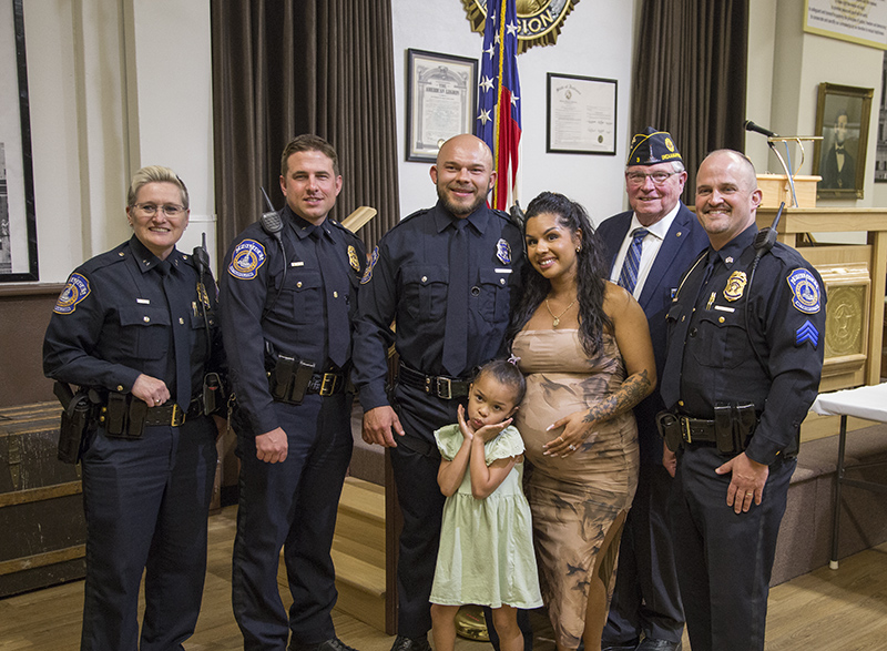 Officer David Woloszyn with his wife and daughter, IMPD colleges and Dan Cunningham from Post #3