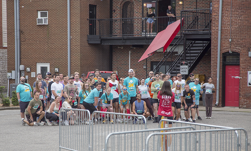 The participants posed for the drone, seen in front of the red door