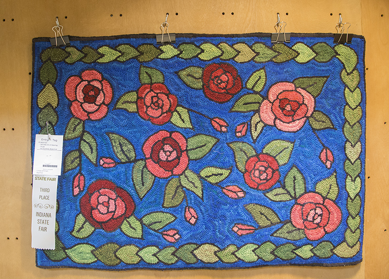 Linda's second hooked rug with a third place ribbon