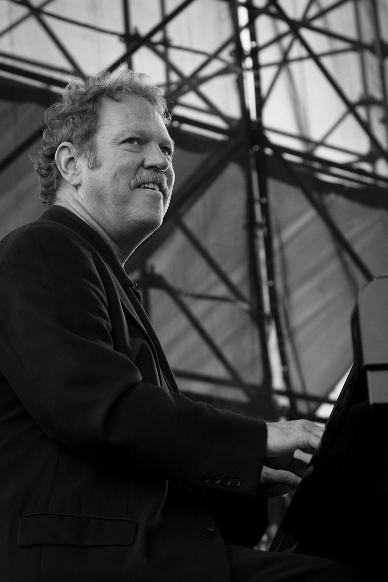 Steve Allee playing piano during a concert.