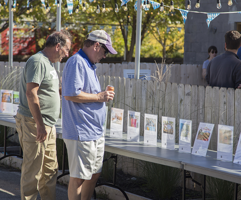 Attendees looking over the silent auction items