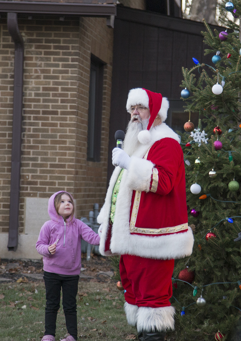 This young lady helped Santa light the tree