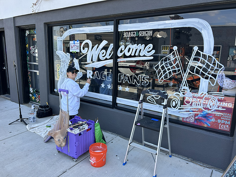 Kimmy painting the mural
